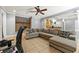 Large living room boasts a stone fireplace, ceiling fan and comfortable sectional sofa at 931 Windsor Creek Dr, Grayson, GA 30017
