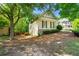 View of the home's rear exterior featuring stone and siding under a shade tree at 931 Windsor Creek Dr, Grayson, GA 30017