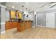 Butler's pantry/wet bar features ample cabinet space, pendant lighting and tile floors at 931 Windsor Creek Dr, Grayson, GA 30017