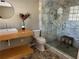 Modern bathroom featuring a marble shower and floating vanity with beautiful natural light at 1053 Allgood Rd, Stone Mountain, GA 30083
