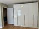 Bedroom with hardwood floors and a large built-in closet with high-gloss doors at 1053 Allgood Rd, Stone Mountain, GA 30083