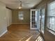 Bedroom featuring hardwood floors, ceiling fan, built-in closet, and access to outdoors at 1053 Allgood Rd, Stone Mountain, GA 30083