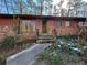 Close-up exterior shot of home entrance featuring a brick facade with decorative shutters and a green door at 1053 Allgood Rd, Stone Mountain, GA 30083