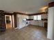 Traditional kitchen featuring wood paneling, white cabinets and appliances, and tile flooring at 1053 Allgood Rd, Stone Mountain, GA 30083