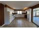 Bright kitchen with white cabinetry and a view to the back porch with a swing at 1053 Allgood Rd, Stone Mountain, GA 30083