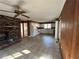 Spacious living room featuring a brick fireplace and ceiling fan at 1053 Allgood Rd, Stone Mountain, GA 30083