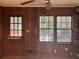 Cozy living room featuring wood paneled walls and a brick fireplace at 1053 Allgood Rd, Stone Mountain, GA 30083