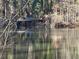 Picturesque pond reflecting sunlight through trees at 1053 Allgood Rd, Stone Mountain, GA 30083