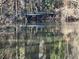 Picturesque pond reflecting sunlight through trees at 1053 Allgood Rd, Stone Mountain, GA 30083