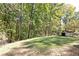 Large wooded lot featuring shed and lush green grass at 255 Shipp Cir, Hiram, GA 30141