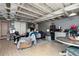 Large basement area featuring wood look floors, a bed, an entertainment area, and a small kitchen area at 255 Shipp Cir, Hiram, GA 30141