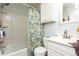 Clean bathroom with white fixtures, floral shower curtain, and storage cabinet at 255 Shipp Cir, Hiram, GA 30141