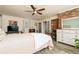 Spacious bedroom featuring brick accent wall, ceiling fan and modern decor at 255 Shipp Cir, Hiram, GA 30141