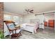 Comfortable bedroom featuring a rocking chair, neutral walls, and a sliding barn door at 255 Shipp Cir, Hiram, GA 30141