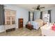 Cozy bedroom with a ceiling fan, decorative armoire, and vintage accents at 255 Shipp Cir, Hiram, GA 30141