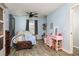 Comfortable bedroom featuring light blue walls, vintage accents, and a ceiling fan at 255 Shipp Cir, Hiram, GA 30141