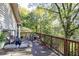 Large deck features wood railings, potted plants, seating area, and beautiful wooded backyard at 255 Shipp Cir, Hiram, GA 30141