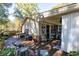 Exterior view of home's rear deck, outdoor seating, brick siding and wooded backyard at 255 Shipp Cir, Hiram, GA 30141