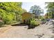 View of the back of the home, with a large driveway and mature trees around the property at 255 Shipp Cir, Hiram, GA 30141