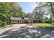 Ranch home with an extended driveway, mature trees and well manicured front yard at 255 Shipp Cir, Hiram, GA 30141