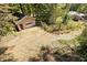 Detached single car garage nestled in wooded backyard with gravel parking area at 255 Shipp Cir, Hiram, GA 30141