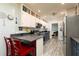 Bright kitchen featuring grey countertops, white cabinets, and stainless steel appliances at 255 Shipp Cir, Hiram, GA 30141