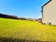 Expansive, well-maintained backyard with lush green grass and privacy fence, perfect for outdoor activities at 2579 Wimberley Pine Ct, Dacula, GA 30019