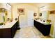 Bright bathroom with tile floor, double vanities, framed mirrors, and bright lighting at 2579 Wimberley Pine Ct, Dacula, GA 30019