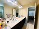 A bathroom featuring double sinks with a white countertop and dark cabinets at 2579 Wimberley Pine Ct, Dacula, GA 30019
