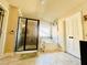 Bathroom featuring glass-enclosed shower, soaking tub, tile floor, and double doors to toilet room at 2579 Wimberley Pine Ct, Dacula, GA 30019