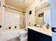 This bathroom includes a shower-tub combo and black hardware at 2579 Wimberley Pine Ct, Dacula, GA 30019