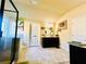Bathroom featuring glass shower, soaking tub, dark vanity, tile floor, and bright overhead lighting at 2579 Wimberley Pine Ct, Dacula, GA 30019