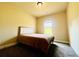 Simple bedroom with neutral tones, a soft bed, and a window offering a peaceful and serene atmosphere at 2579 Wimberley Pine Ct, Dacula, GA 30019