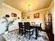 Cozy dining room features elegant wainscoting, modern light fixture, and stylish decor creating a welcoming space at 2579 Wimberley Pine Ct, Dacula, GA 30019