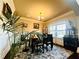 Bright dining room with a large window, decorative cabinet, and stylish table perfect for Gathering meals at 2579 Wimberley Pine Ct, Dacula, GA 30019