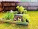 A raised garden bed offers a touch of green, and fresh vegetables in the property's backyard at 2579 Wimberley Pine Ct, Dacula, GA 30019