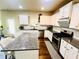 Kitchen featuring white cabinets, granite countertops, stainless steel appliances, and a tiled backsplash at 2579 Wimberley Pine Ct, Dacula, GA 30019