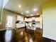 Charming kitchen with white cabinets, a center island, and dark wood floors and door to outside at 2579 Wimberley Pine Ct, Dacula, GA 30019