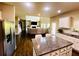 View of the kitchen island looking into the living room with fireplace at 2579 Wimberley Pine Ct, Dacula, GA 30019