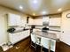 Eat-in kitchen features white cabinets, granite countertops, stainless steel appliances, and a tiled backsplash at 2579 Wimberley Pine Ct, Dacula, GA 30019