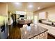 View of the kitchen island looking into the living room with fireplace at 2579 Wimberley Pine Ct, Dacula, GA 30019