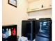 Laundry room with front load washer and dryer, a shelf with supplies, and a picture frame at 2579 Wimberley Pine Ct, Dacula, GA 30019
