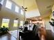 Open-concept living room with hardwood floors, high ceilings, and a view into the adjacent kitchen ideal for entertaining at 2579 Wimberley Pine Ct, Dacula, GA 30019