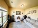 Comfortable living room with a cozy sofa, stylish rug, and large window offering natural light and a relaxing ambiance at 2579 Wimberley Pine Ct, Dacula, GA 30019