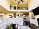 Bright living room features a large sectional sofa, fireplace, and dark hardwood floors at 2579 Wimberley Pine Ct, Dacula, GA 30019