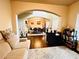 Open living space showcasing hardwood floors, an arched entrance to the dining room, and comfortable furnishings at 2579 Wimberley Pine Ct, Dacula, GA 30019