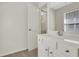 Bathroom vanity with white cabinets, chrome hardware, and a view to a secondary room at 3485 Walnut Rdg, Atlanta, GA 30349