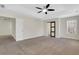 Bedroom featuring a tray ceiling, fan, and a sliding barn door at 3485 Walnut Rdg, Atlanta, GA 30349