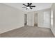 Spacious bedroom with neutral carpet, ceiling fan, and three doors at 3485 Walnut Rdg, Atlanta, GA 30349