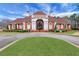 Community clubhouse with brick facade, elegant entry, and manicured lawn at 3485 Walnut Rdg, Atlanta, GA 30349